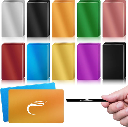 A collection of colorful aluminum wallet cards arranged in a grid, showcasing various vibrant colors including silver, gold, green, blue, and pink. In the foreground, a hand is holding a sleek black card, demonstrating its slim design.