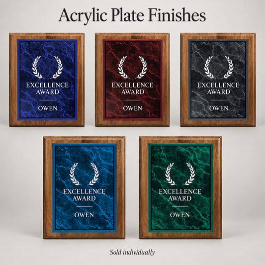 Five acrylic plated walnut award plaques displayed on a light gray background under the heading 'Acrylic Plate Finishes.' The plaque plates feature marble-style finishes in blue, red, black, and green, each with a white laurel wreath and the text 'EXCELLENCE AWARD' and the name 'OWEN.
