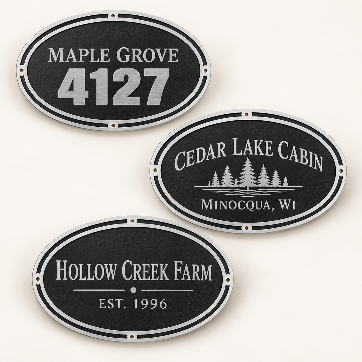 Three personalized oval cast aluminum wall signs for an address, cabin, and farm