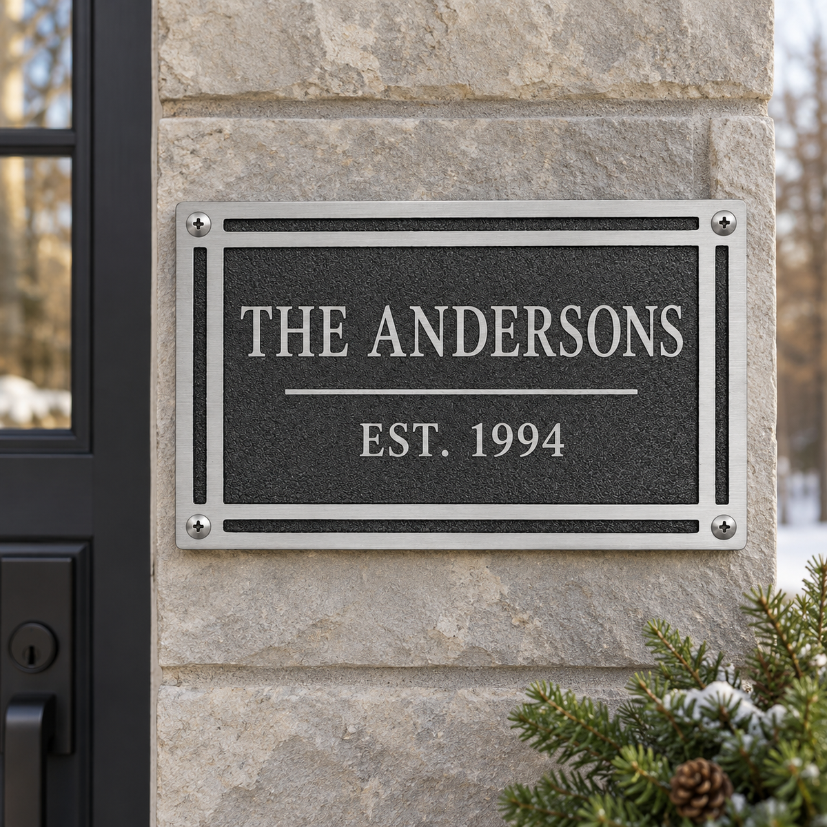Personalized black rectangular cast aluminum Andersons plaque mounted beside an exterior door