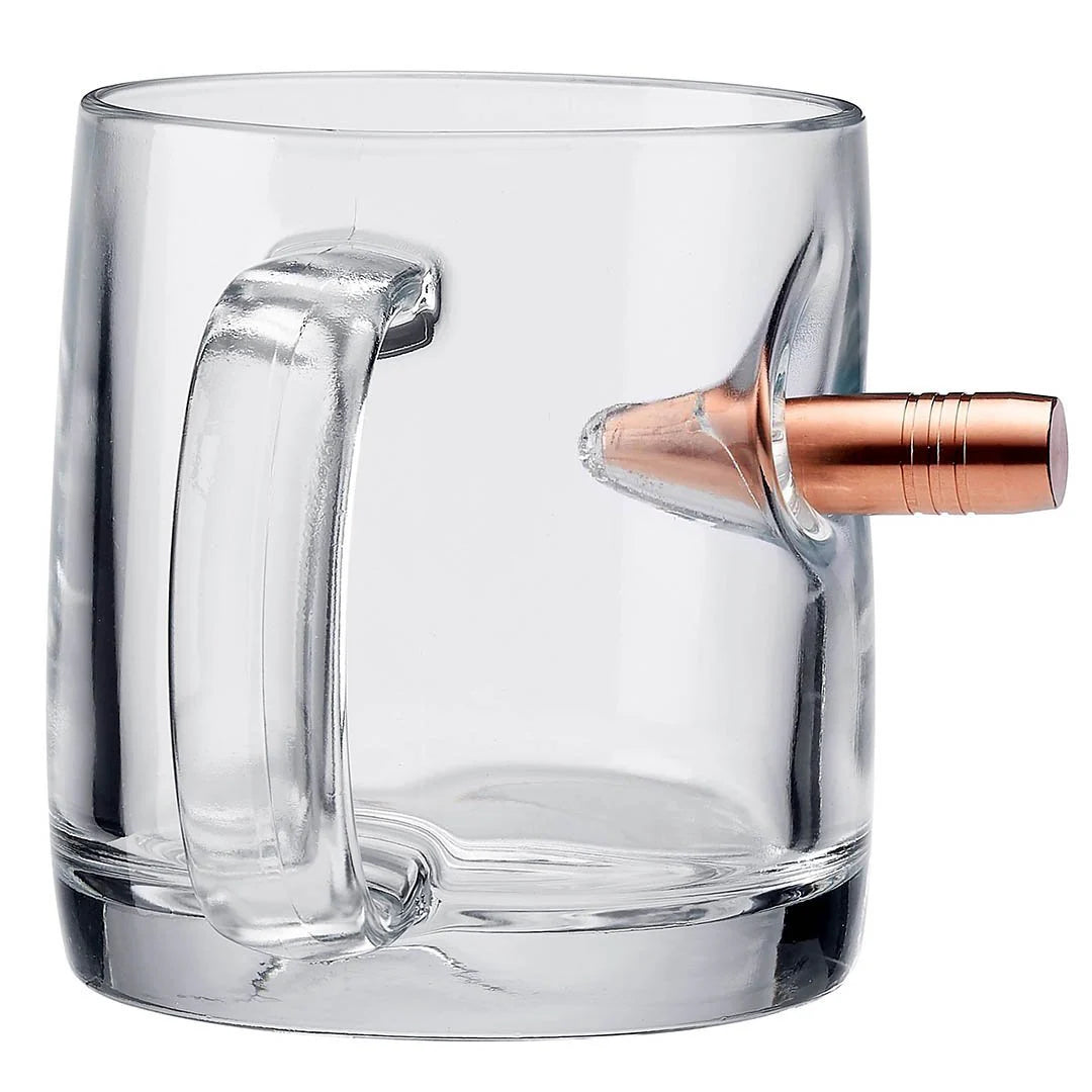 Clear glass mug with a bullet embedment on a white background