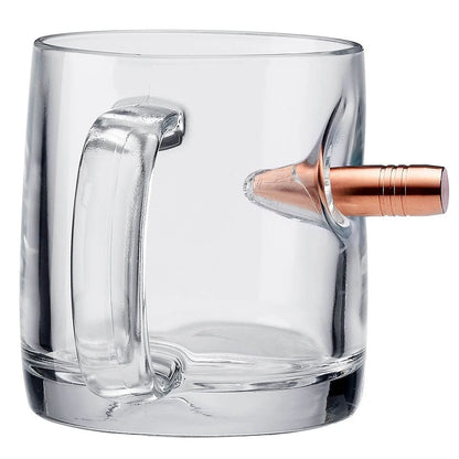Clear glass mug with a bullet embedment on a white background