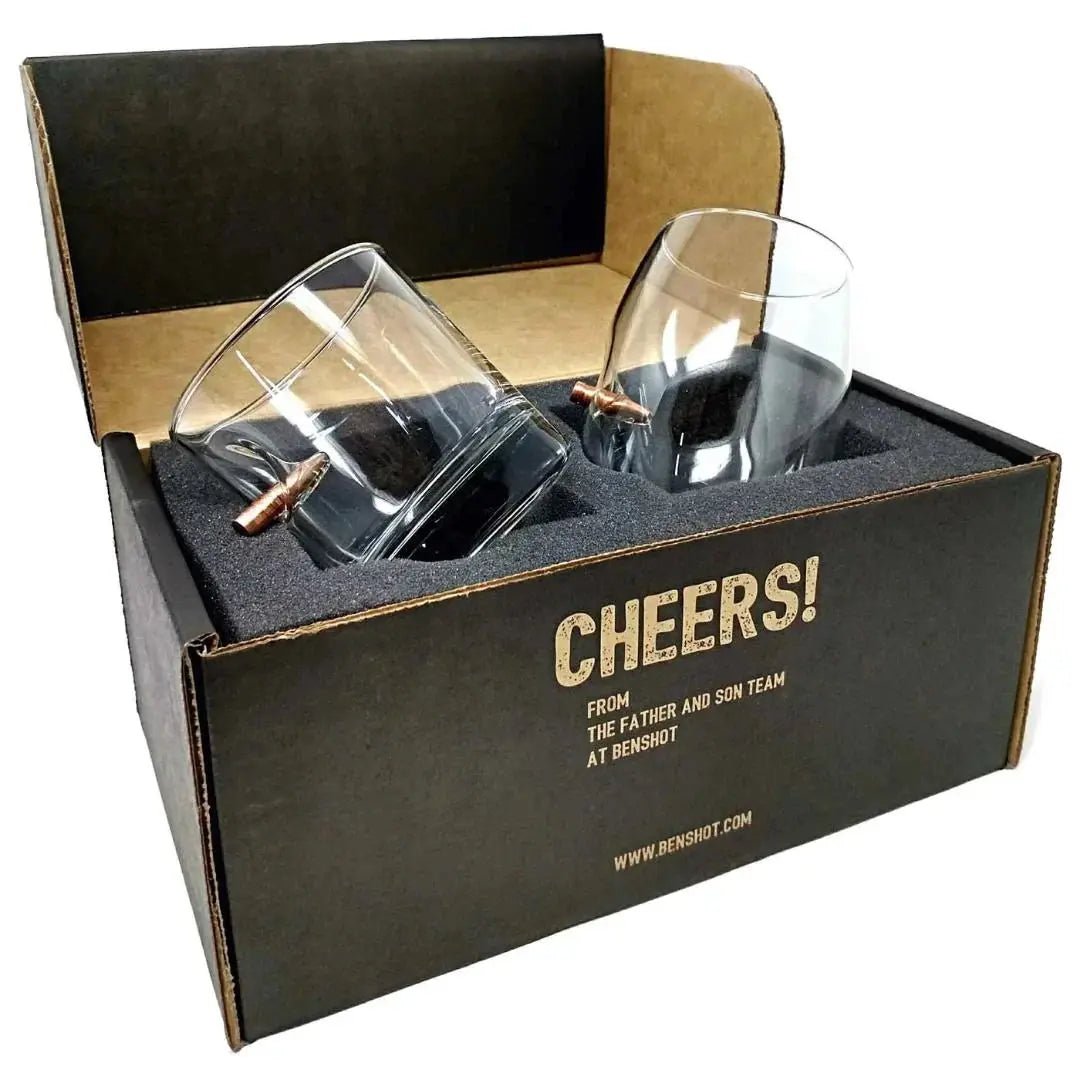 Two clear glasses in a black box with 'Cheers!' text and website address.