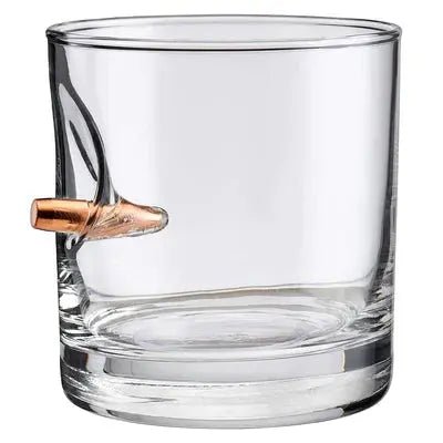 Clear glass rocks glass with a bullet embedment on a white background