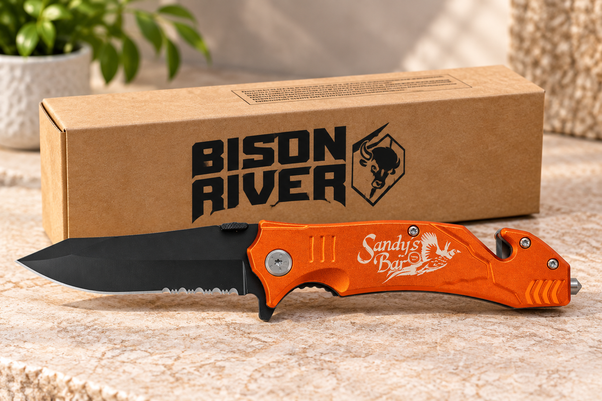Orange Bison River folding rescue knife with personalized Sandy’s Bar engraving, black partially serrated blade, and product box.