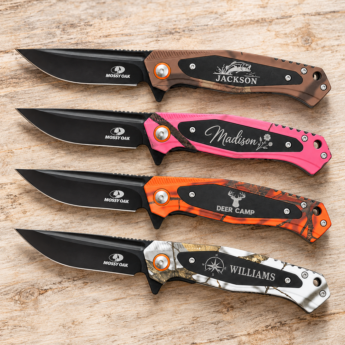 Four personalized Bison River Mossy Oak everyday carry knives in brown, pink, orange, and white camo on a light wood background.