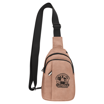 Beige sling bag with black strap on a blank background