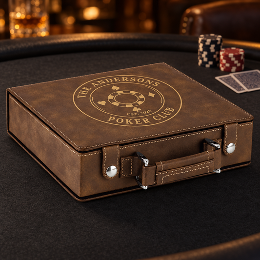 A brown faux-leather poker case with silver hardware sits on a dark felt poker table. The lid is embossed with a circular gold logo reading 'THE ANDERSONS POKER CLUB EST.