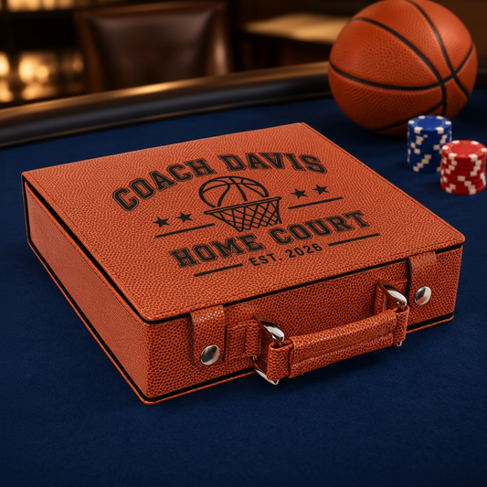 A personalized brown faux-leather poker case engraved with 'COACH DAVIS HOME COURT EST. 2026' and a basketball hoop graphic, placed on a dark blue felt surface with a basketball and poker chips in the background.