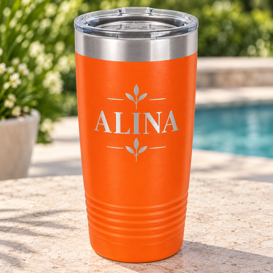 Orange 20 oz ringneck tumbler with silver ALINA floral engraving and clear lid.