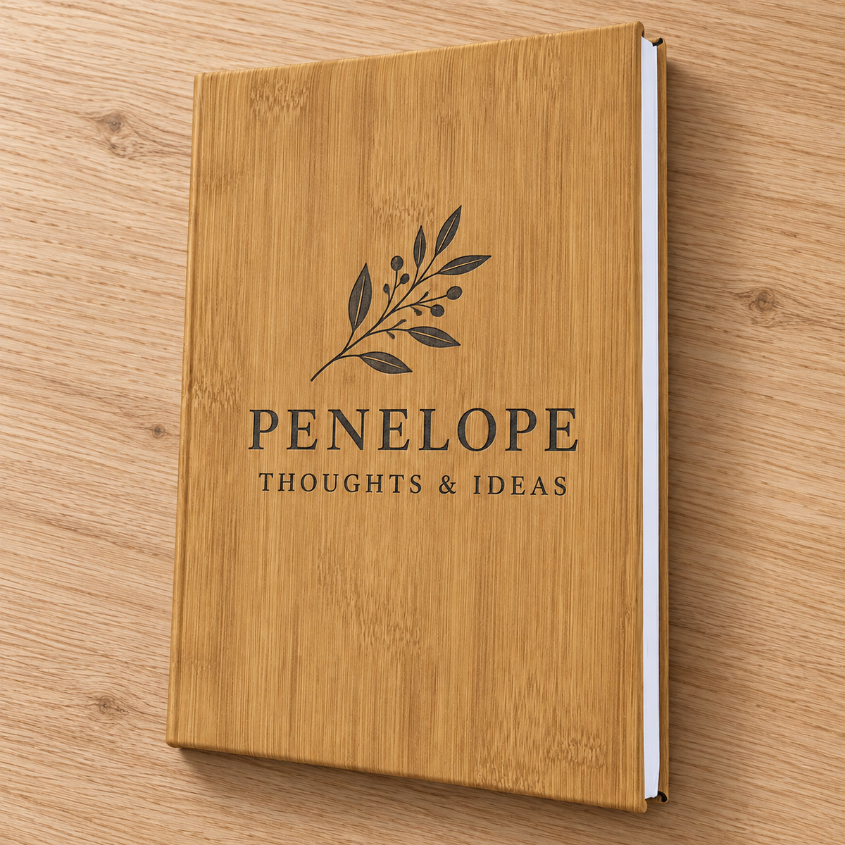 Small hardbound bamboo-look leatherette journal with dark PENELOPE botanical engraving.