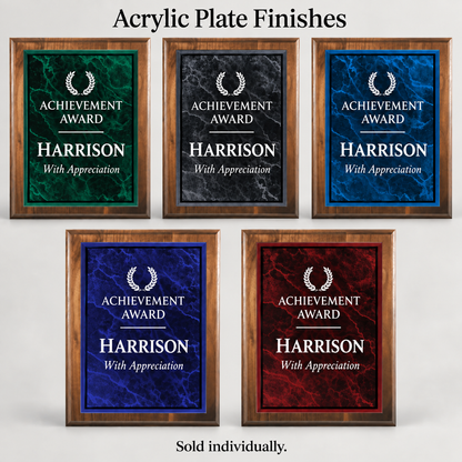Five framed acrylic achievement plaques on a light gray background, each with a different colored marble-style face: green, black, blue, purple, and red variants. The top text reads 'Acrylic Plate Finishes' and the bottom text reads 'Sold individually.