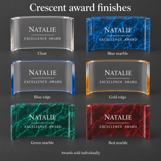 Six award plaque finishes labeled 'Crescent award finishes' on a dark gray background. The options shown are Clear, Blue marble, Blue edge, Gold edge, Green marble, and Red marble, each with a curved rectangular plaque engraved with 'NATALIE EXCELLENCE AWARD'.