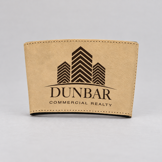 Light Brown leatherette cup sleeve with dark DUNBAR COMMERCIAL REALTY sample engraving on a neutral studio surface.