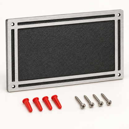 Blank black rectangular cast aluminum wall plaque with screws and red wall anchors