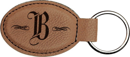 Dark Brown personalized oval leatherette keychains with example engraving