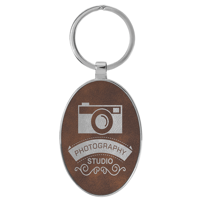 Rustic/Silver personalized metal-frame oval leatherette keychains with example engraving