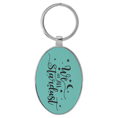 Teal personalized metal-frame oval leatherette keychains with example engraving