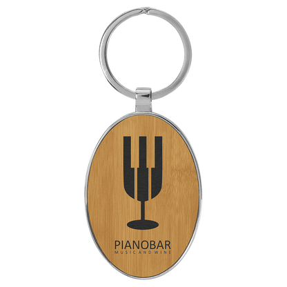 Bamboo personalized metal-frame oval leatherette keychains with example engraving