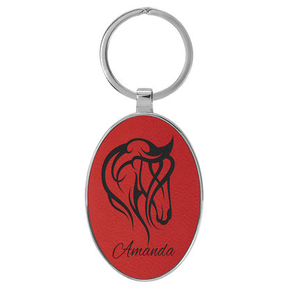 Red personalized metal-frame oval leatherette keychains with example engraving