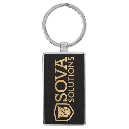 Black/Gold personalized metal-frame rectangle leatherette keychains with example engraving