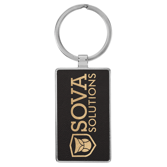 Black/Gold personalized metal-frame rectangle leatherette keychains with example engraving