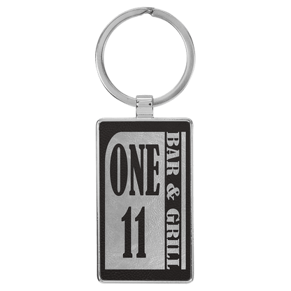 Black/Silver personalized metal-frame rectangle leatherette keychains with example engraving