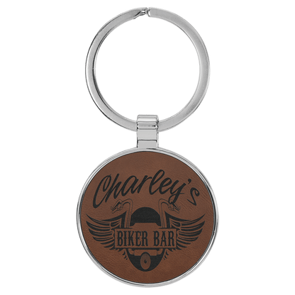 Dark Brown personalized metal-frame round leatherette keychains with example engraving