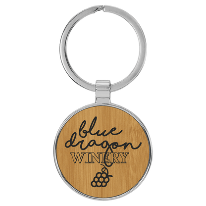 Bamboo personalized metal-frame round leatherette keychains with example engraving