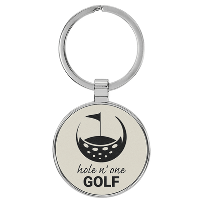 White personalized metal-frame round leatherette keychains with example engraving