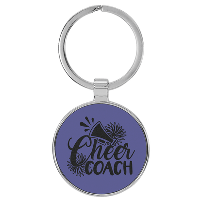 Purple personalized metal-frame round leatherette keychains with example engraving