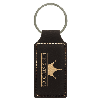 Black/Gold personalized rectangle leatherette keychains with example engraving