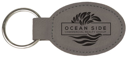 Gray personalized oval leatherette keychains with example engraving