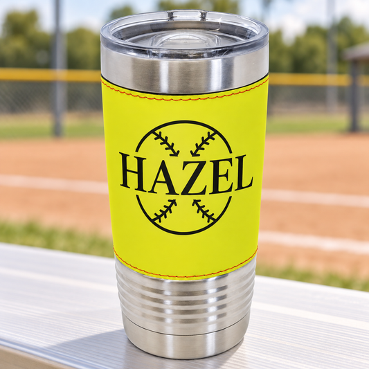 Yellow softball-style 20 oz tumbler with red stitching, black HAZEL engraving and clear slider lid.