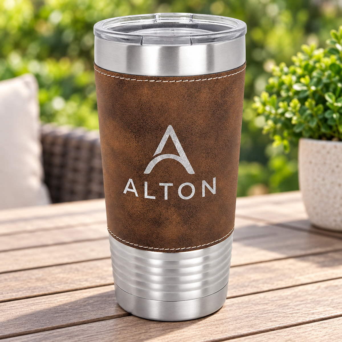 Brown/Silver 20 oz leatherette tumbler with silver ALTON engraving, light stitching and clear lid.