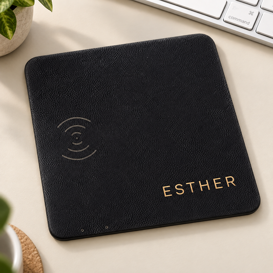 Black/Gold leatherette wireless charging mat with gold ESTHER engraving and embossed charging symbol.