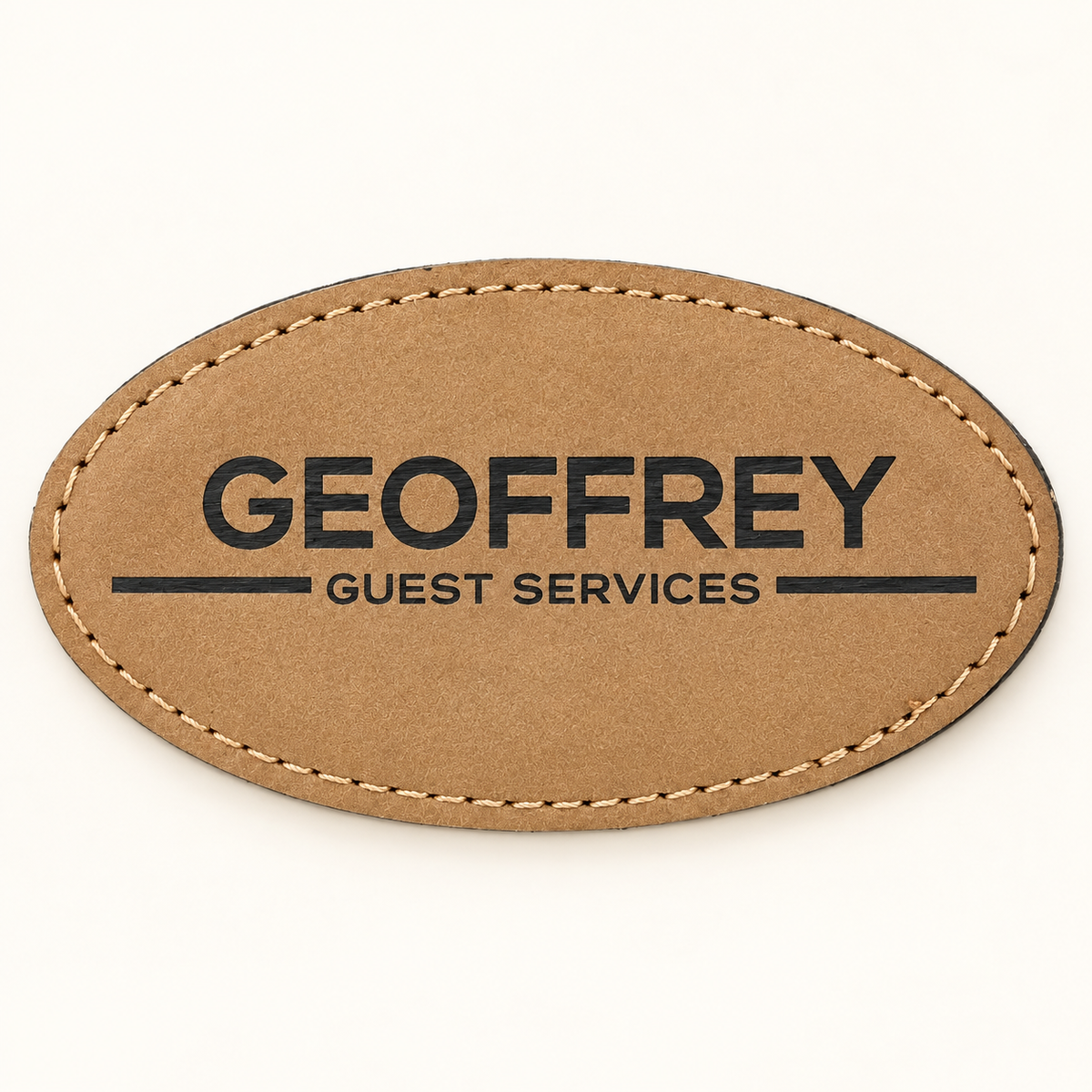 Light Brown oval leatherette magnetic name badge with dark GEOFFREY Guest Services engraving and stitched edge.