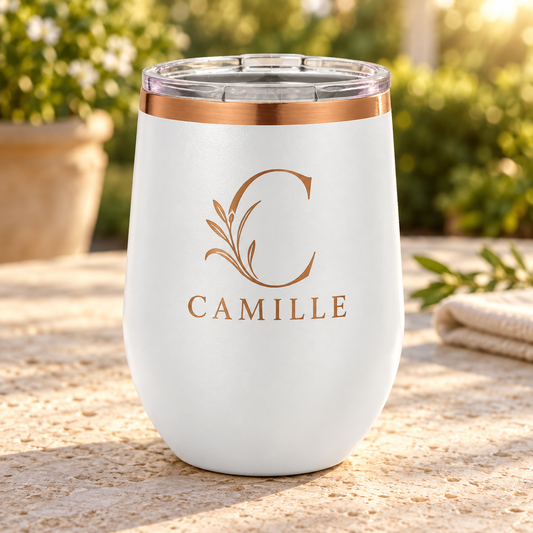 White 12 oz ion plated stemless wine tumbler with rose gold CAMILLE floral engraving and clear lid.