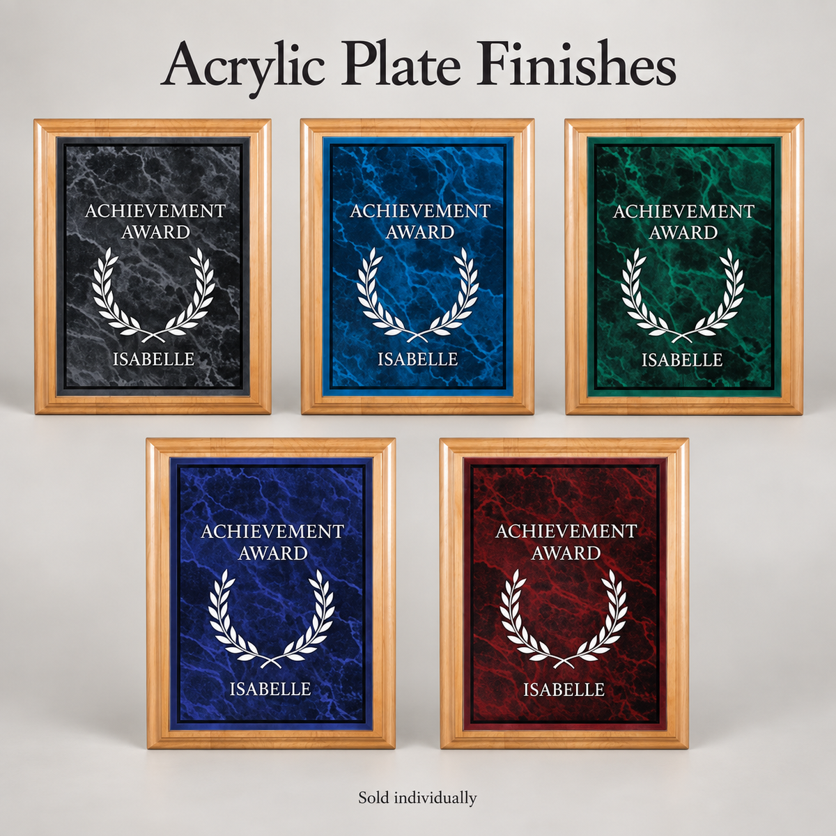 Five red alder award plaques showing different marble finishes: black, blue, green, dark blue, and red. Each one features a white laser etched laurel wreath and the text 'ACHIEVEMENT AWARD' and 'ISABELLE'.