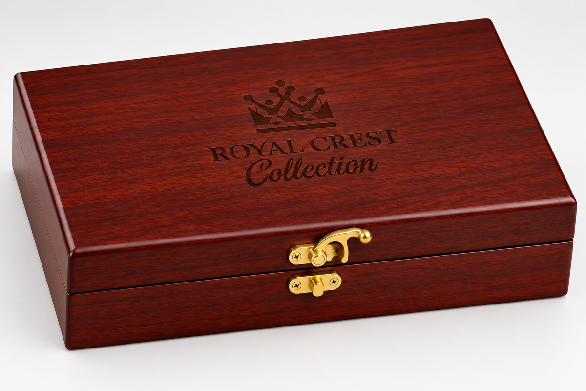 A rectangular reddish-brown wooden presentation box with a textured finish, featuring an engraved crown logo and the text 'ROYAL CREST Collection' on the lid, secured with a gold-tone clasp on a white background.