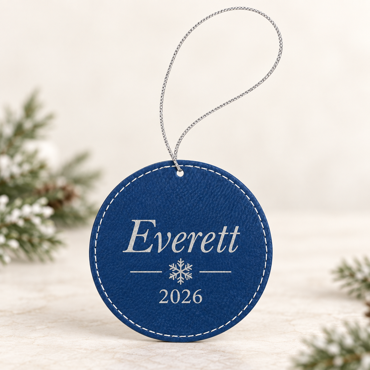 Blue and silver round leatherette ornament personalized with Everett and 2026