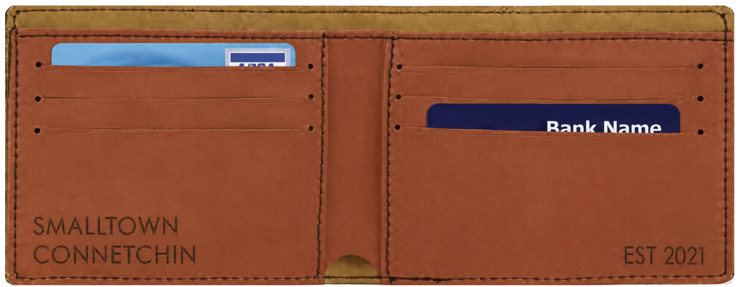 A brown leather bifold wallet shown open, with card slots and a cash pocket. The left side is printed with 'SMALLTOWN CONNETCHIN' and the right side is printed with 'EST 2021'.