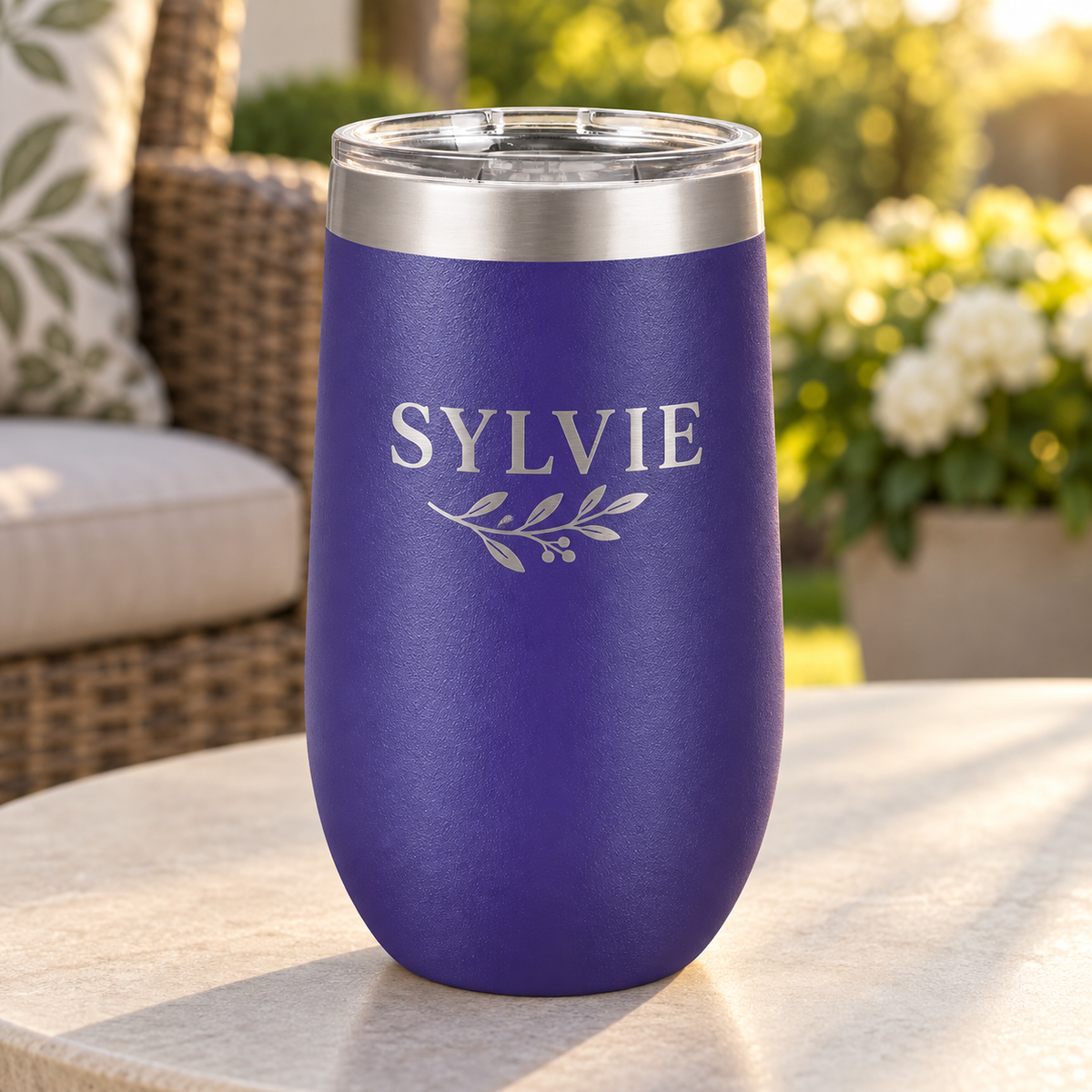 Purple/Silver 16 oz stemless tumbler with SYLVIE leaf engraving and clear lid.