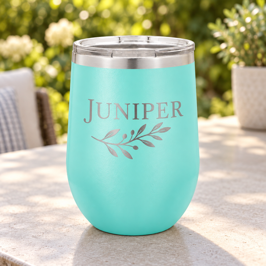 Teal 12 oz stemless wine tumbler with silver JUNIPER leaf engraving and clear lid.